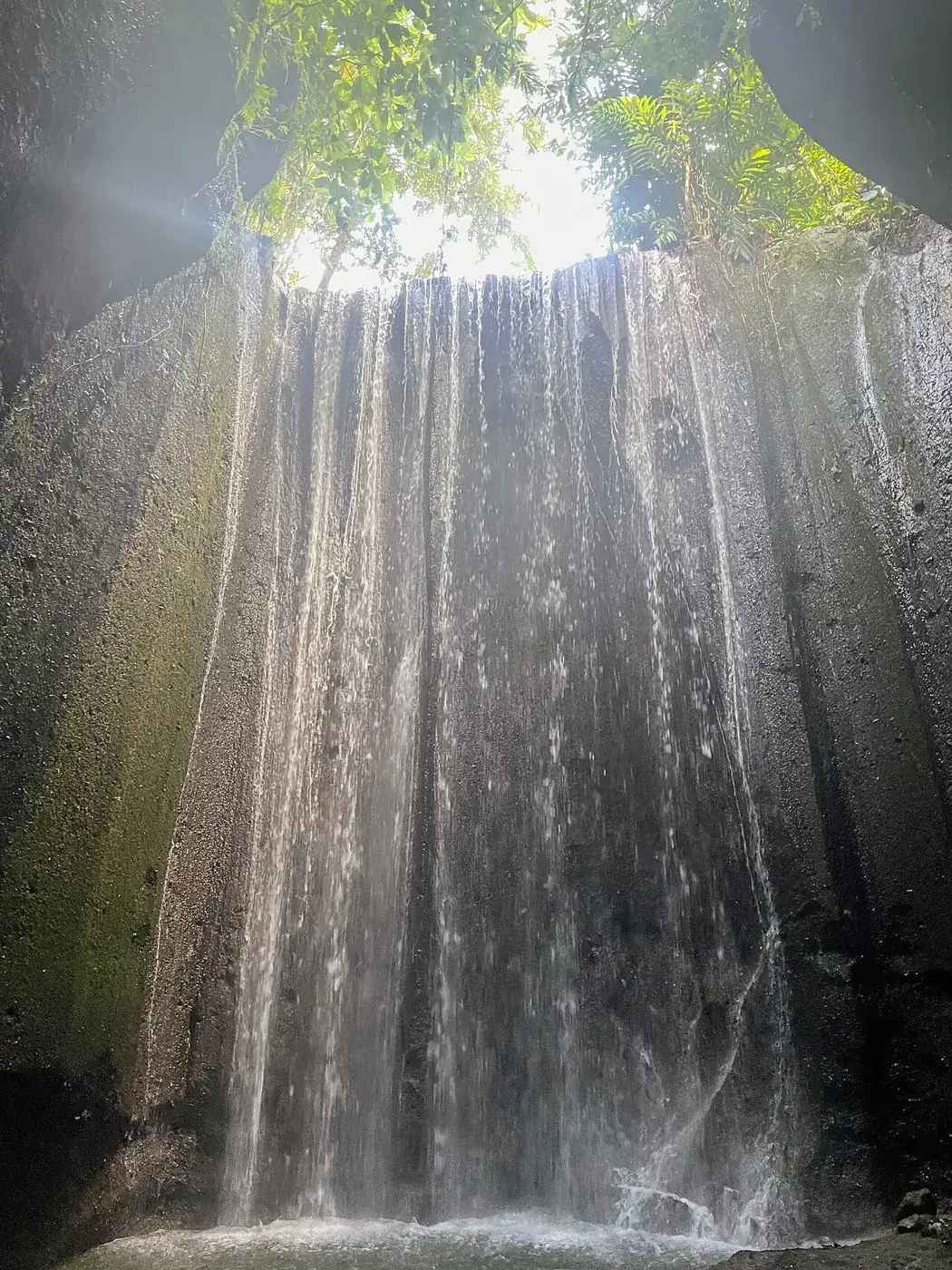 Light above Tukad Cepung Waterfall between rock walls