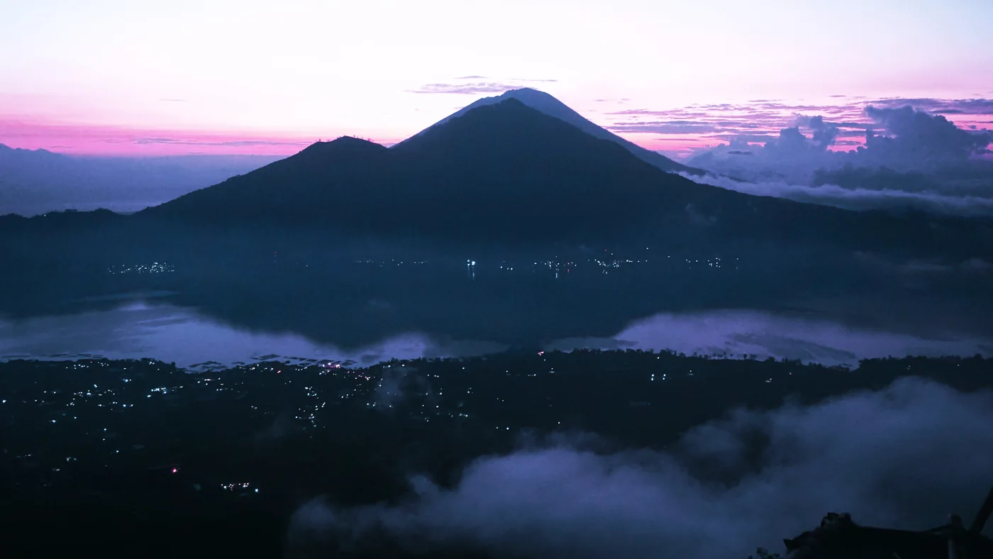 View from Mount Batur over the lake and mountains before sunrise — View from Mount Batur · visibility varies each day