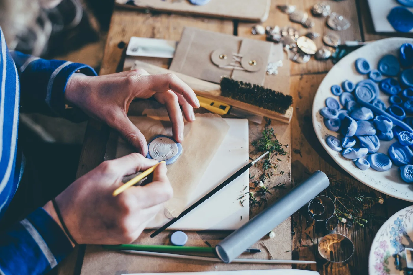 Hands making silver jewellery at a workbench — Making silver jewellery · illustrative photo